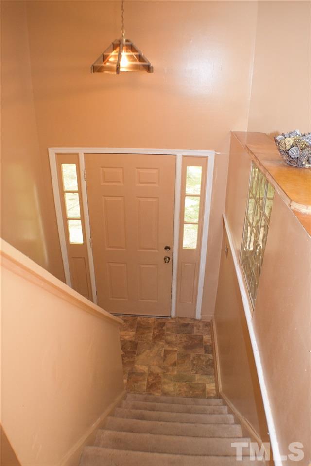 7613 Mine Valley Road Raleigh, NC 27615 - Photo 14 of 24 a view of a livingroom with wooden floor and stairs