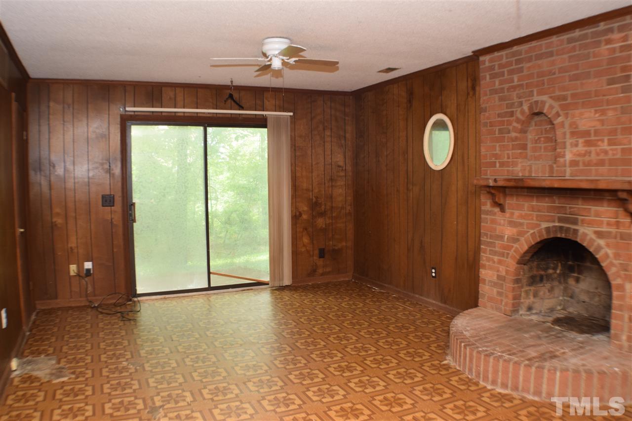 7613 Mine Valley Road Raleigh, NC 27615 - Photo 18 of 24 a living room with furniture and a fireplace