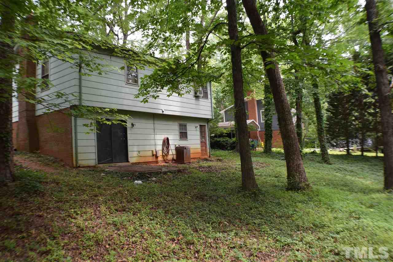 7613 Mine Valley Road Raleigh, NC 27615 - Photo 3 of 24 a view of a house with backyard and a tree