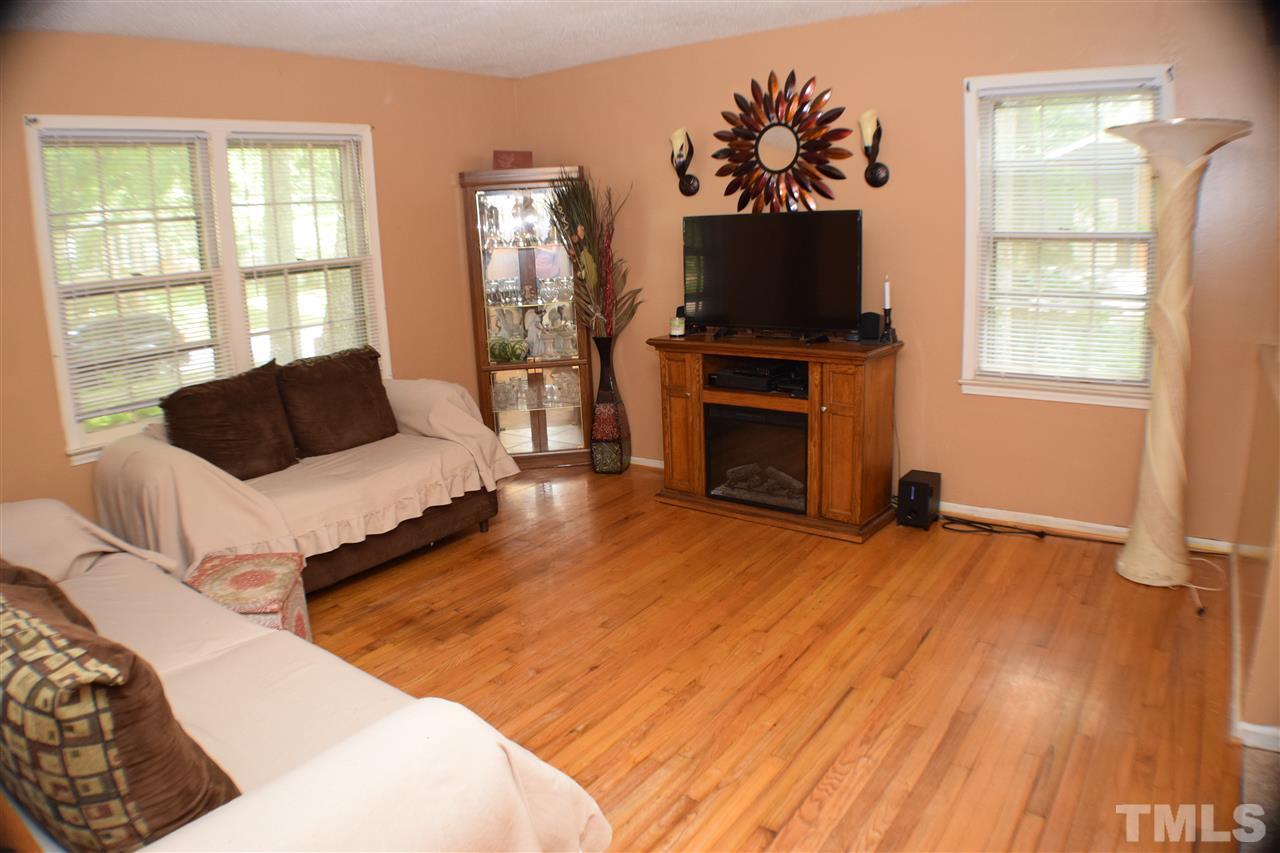 7613 Mine Valley Road Raleigh, NC 27615 - Photo 4 of 24 a living room with furniture and a flat screen tv