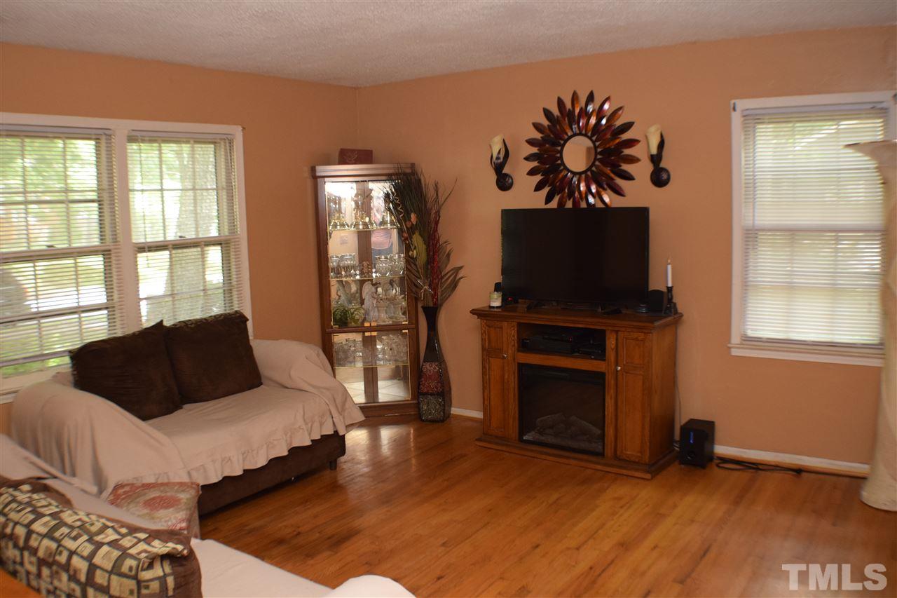 7613 Mine Valley Road Raleigh, NC 27615 - Photo 6 of 24 a living room with furniture fireplace and flat screen tv