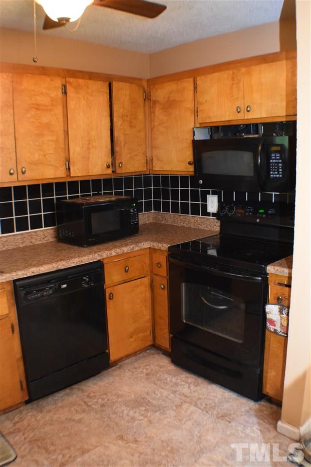 7613 Mine Valley Road Raleigh, NC 27615 - Photo 8 of 24 a kitchen with a sink a stove and a microwave
