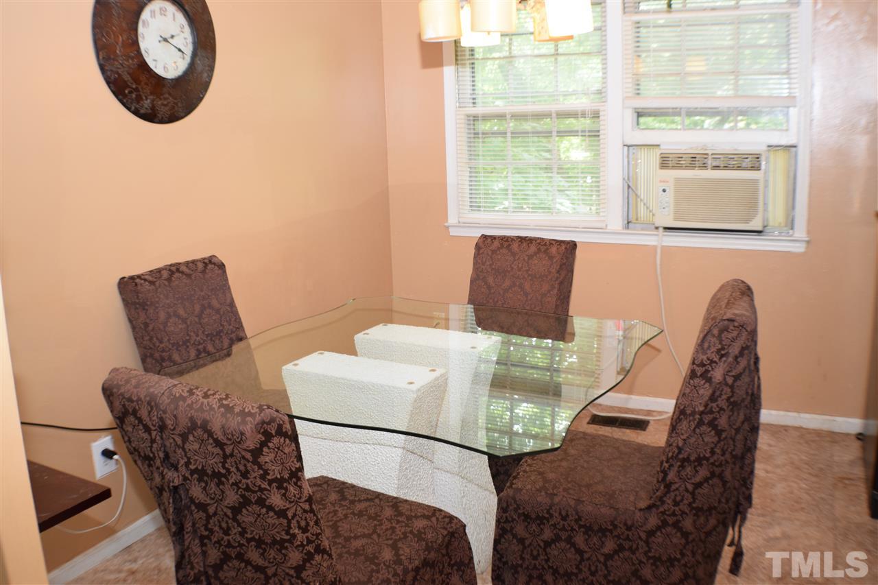 7613 Mine Valley Road Raleigh, NC 27615 - Photo 9 of 24 a view of a dining room with furniture and a window