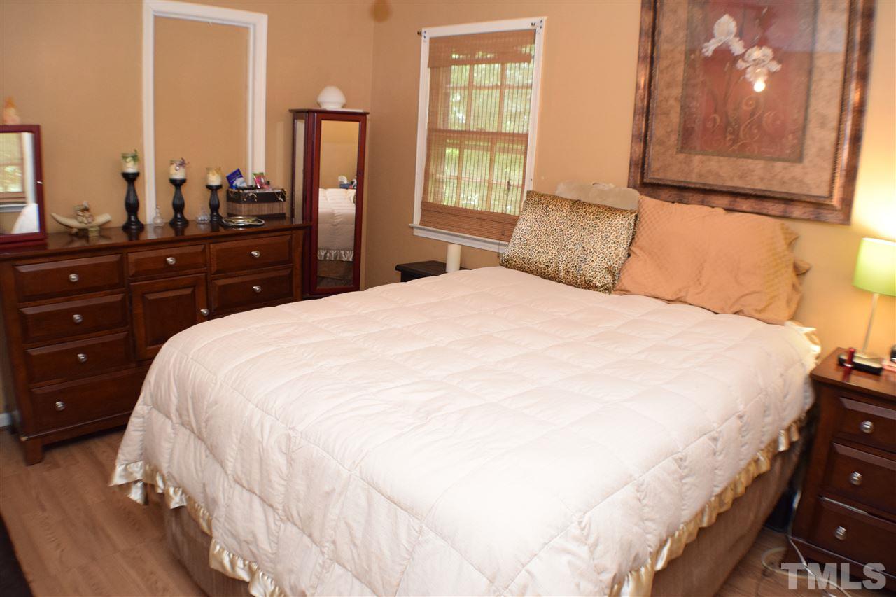 7613 Mine Valley Road Raleigh, NC 27615 - Photo 10 of 24 a bedroom with a bed and wooden floor