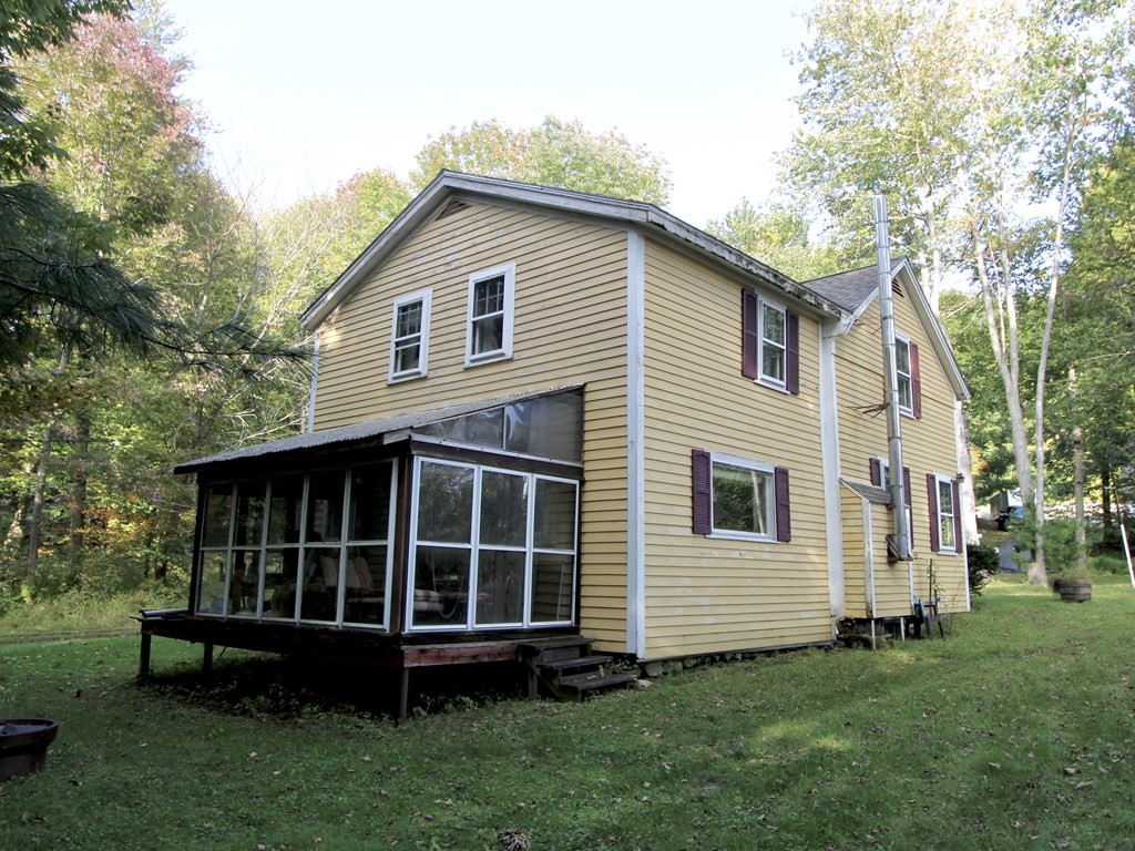 171 Chapel Street Leicester, MA 01524 - Photo 4 of 10 a view of a house with a yard and large trees