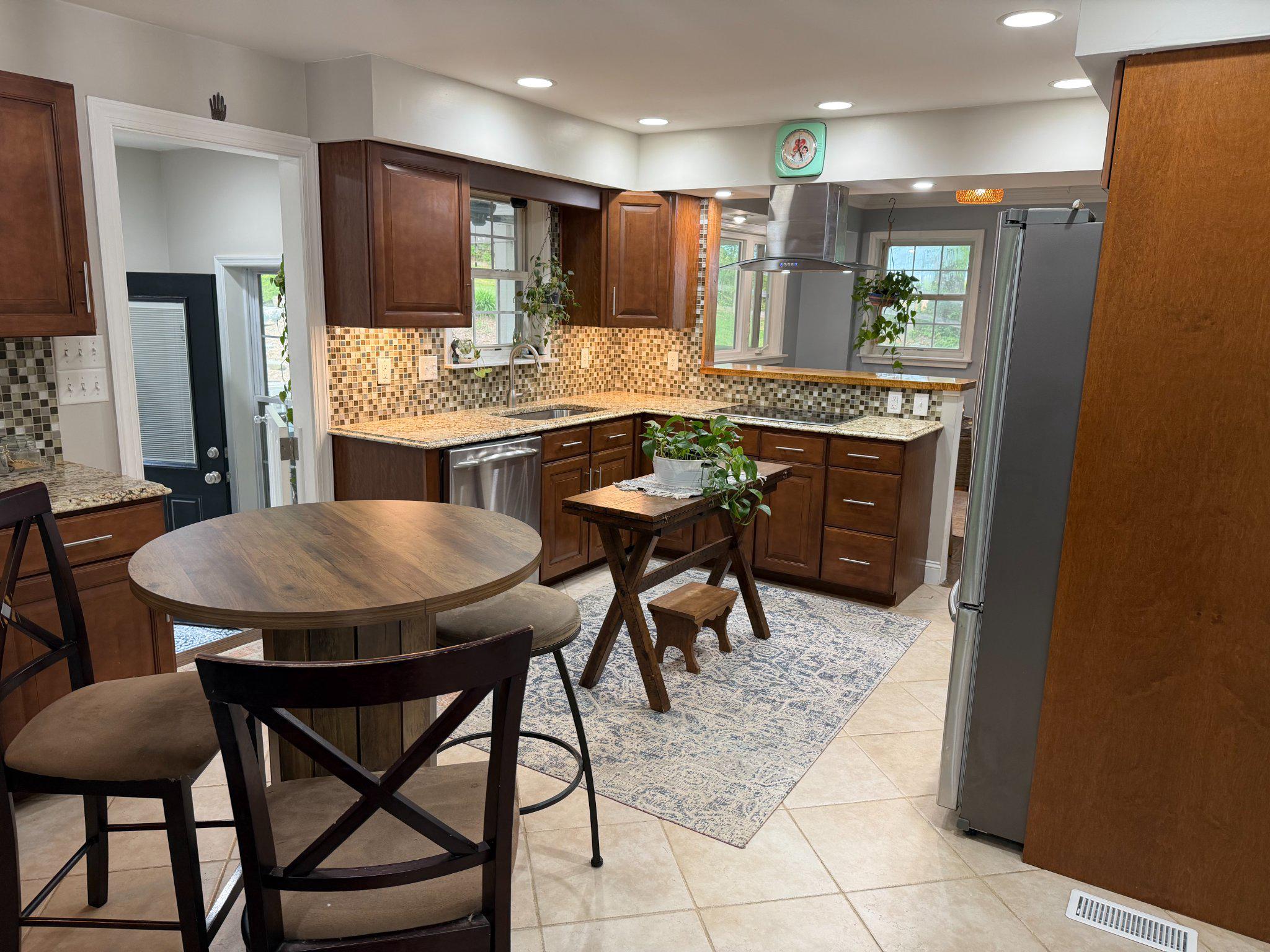 4001 Young Road Manchester, MD 21102 - Photo 11 of 65 a kitchen with stainless steel appliances kitchen island granite countertop a table chairs and a refrigerator