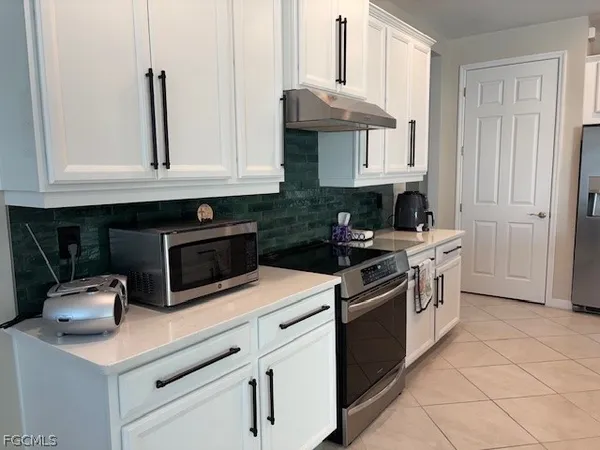 a living room with furniture a rug and a chandelier