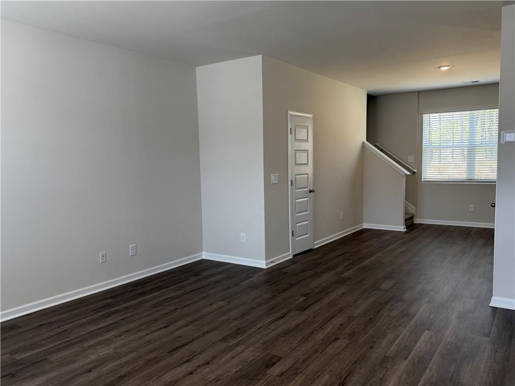 79 Holland Cove Winder, GA 30680 - Photo 4 of 25 a view of an empty room with wooden floor and a window