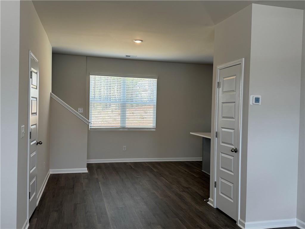79 Holland Cove Winder, GA 30680 - Photo 5 of 25 an empty room with wooden floor closet and windows
