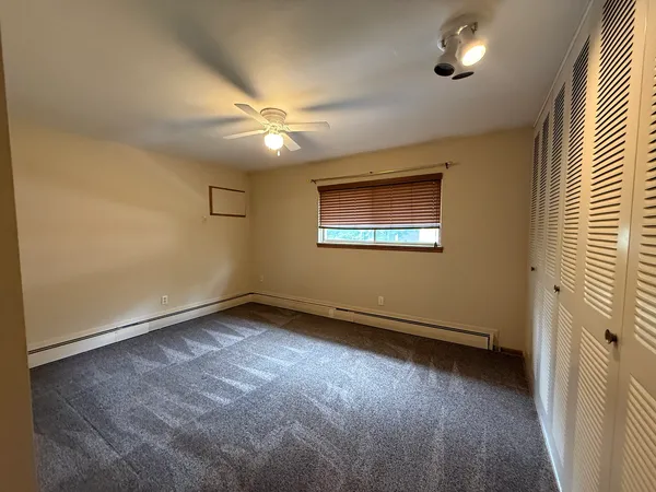 an empty room with a window and a projector