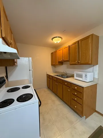 a kitchen with stainless steel appliances a stove a sink and a microwave