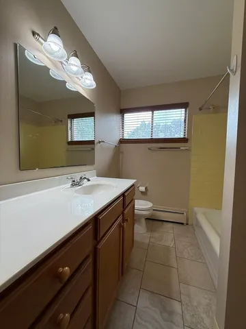 a bathroom with a sink a vanity and a mirror