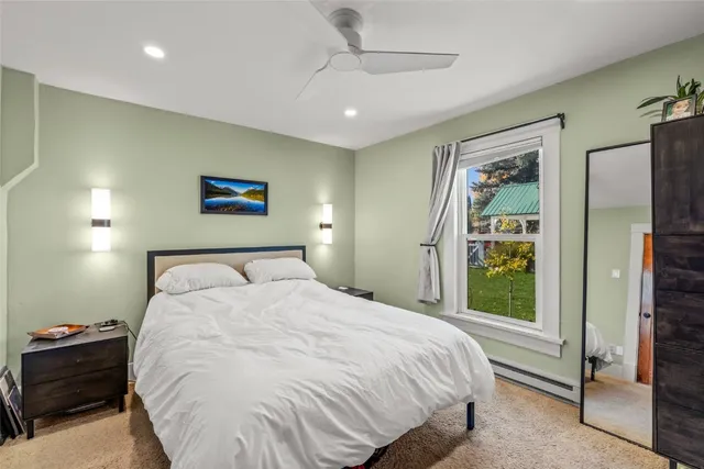 a bedroom with a large bed and a window