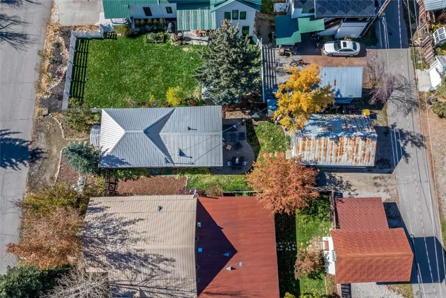 an aerial view of a house with a yard