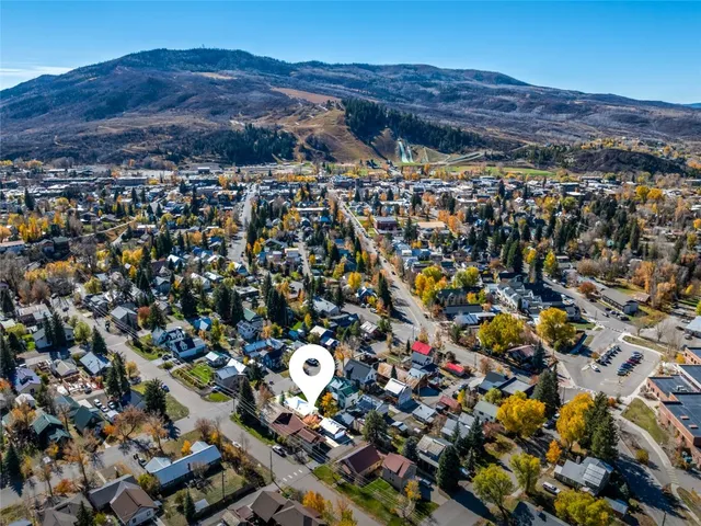 an aerial view of residential house and sandy dunes