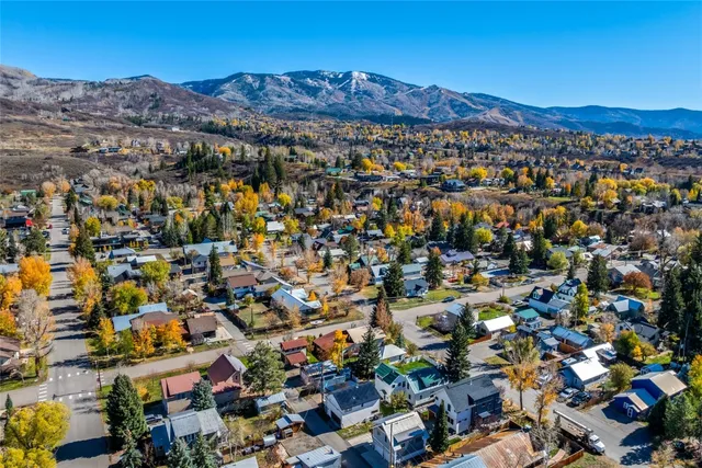 an aerial view of residential house and sandy dunes
