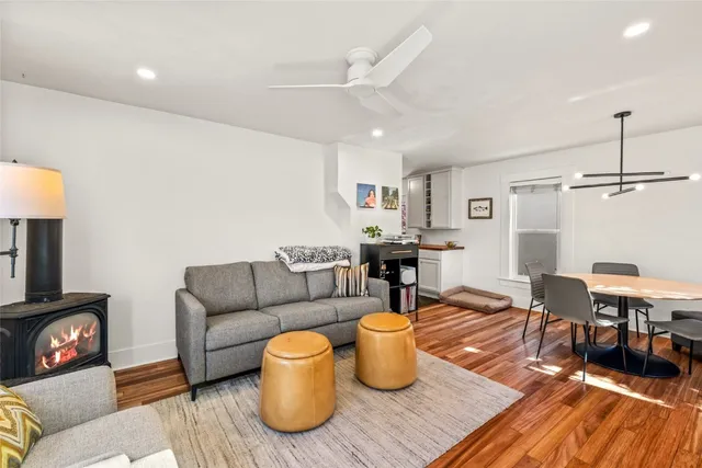 a living room with furniture a rug and a fireplace