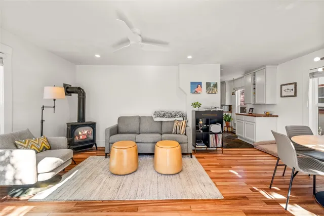 a living room with lots of furniture and a wooden floor