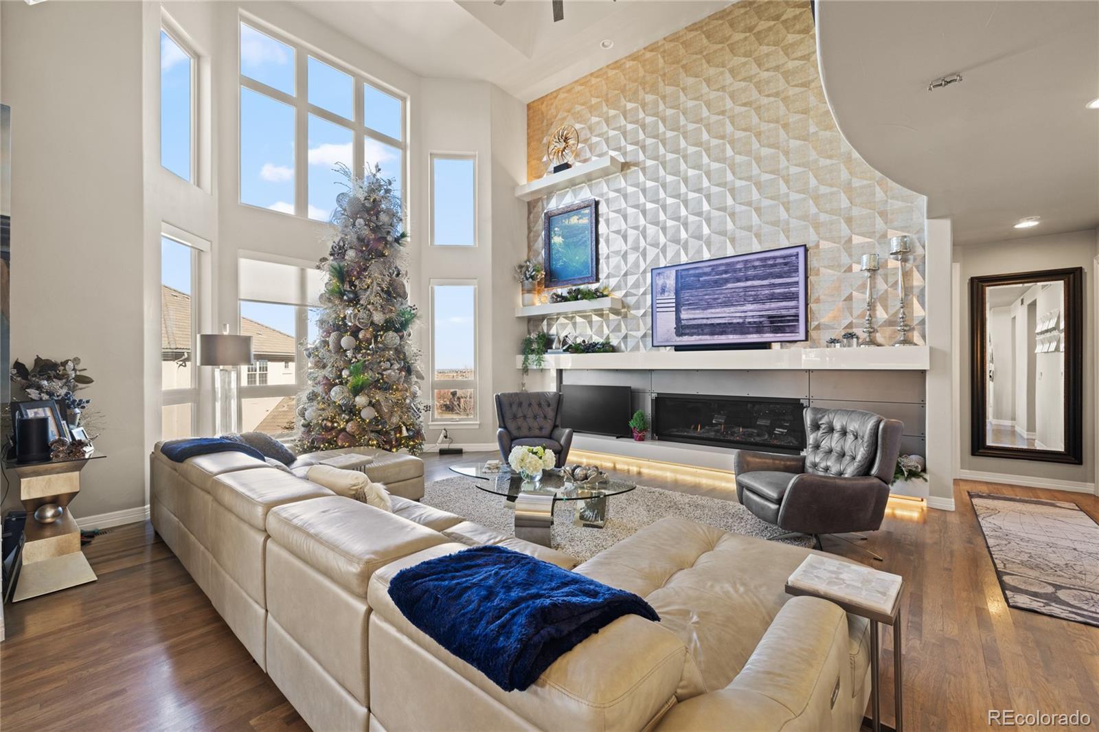 8751 Crooked Stick Place Lone Tree, CO 80124 - Photo 11 of 50 a living room with furniture a fireplace and a table
