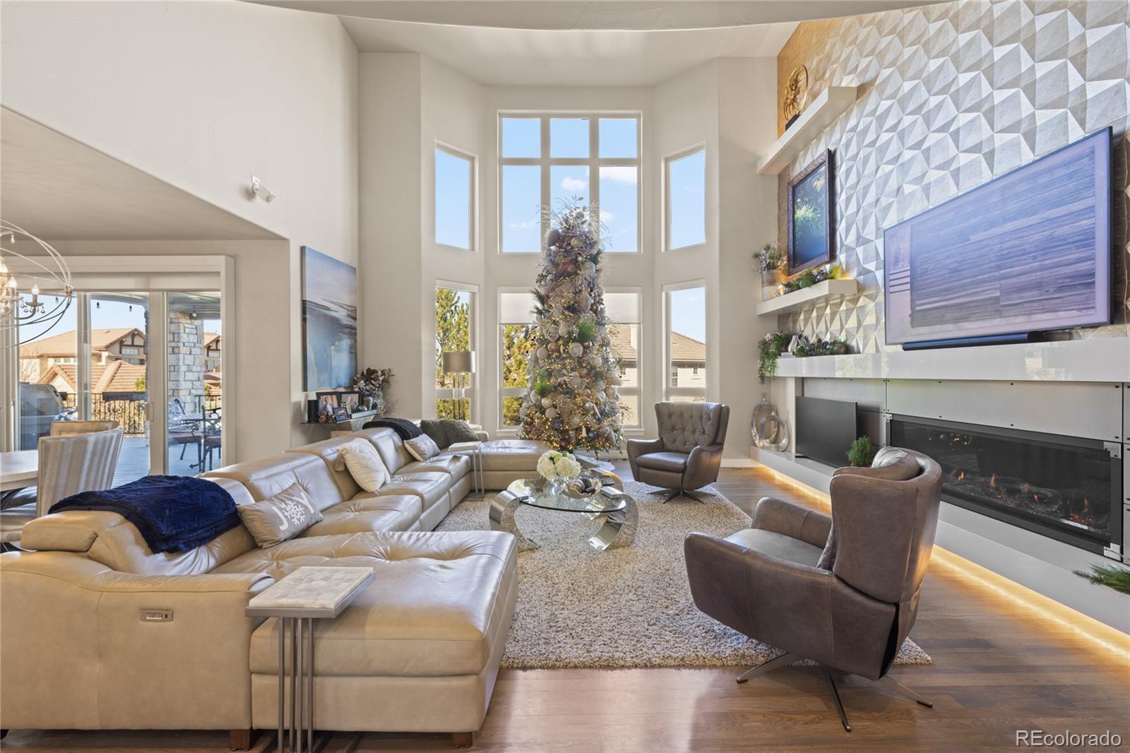 8751 Crooked Stick Place Lone Tree, CO 80124 - Photo 14 of 50 a living room with furniture fireplace and large windows