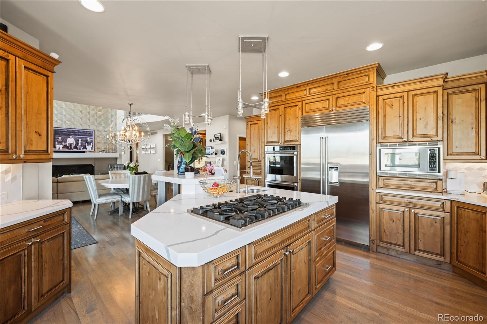 8751 Crooked Stick Place Lone Tree, CO 80124 - Photo 18 of 50 a kitchen with a stove a sink dishwasher and a refrigerator