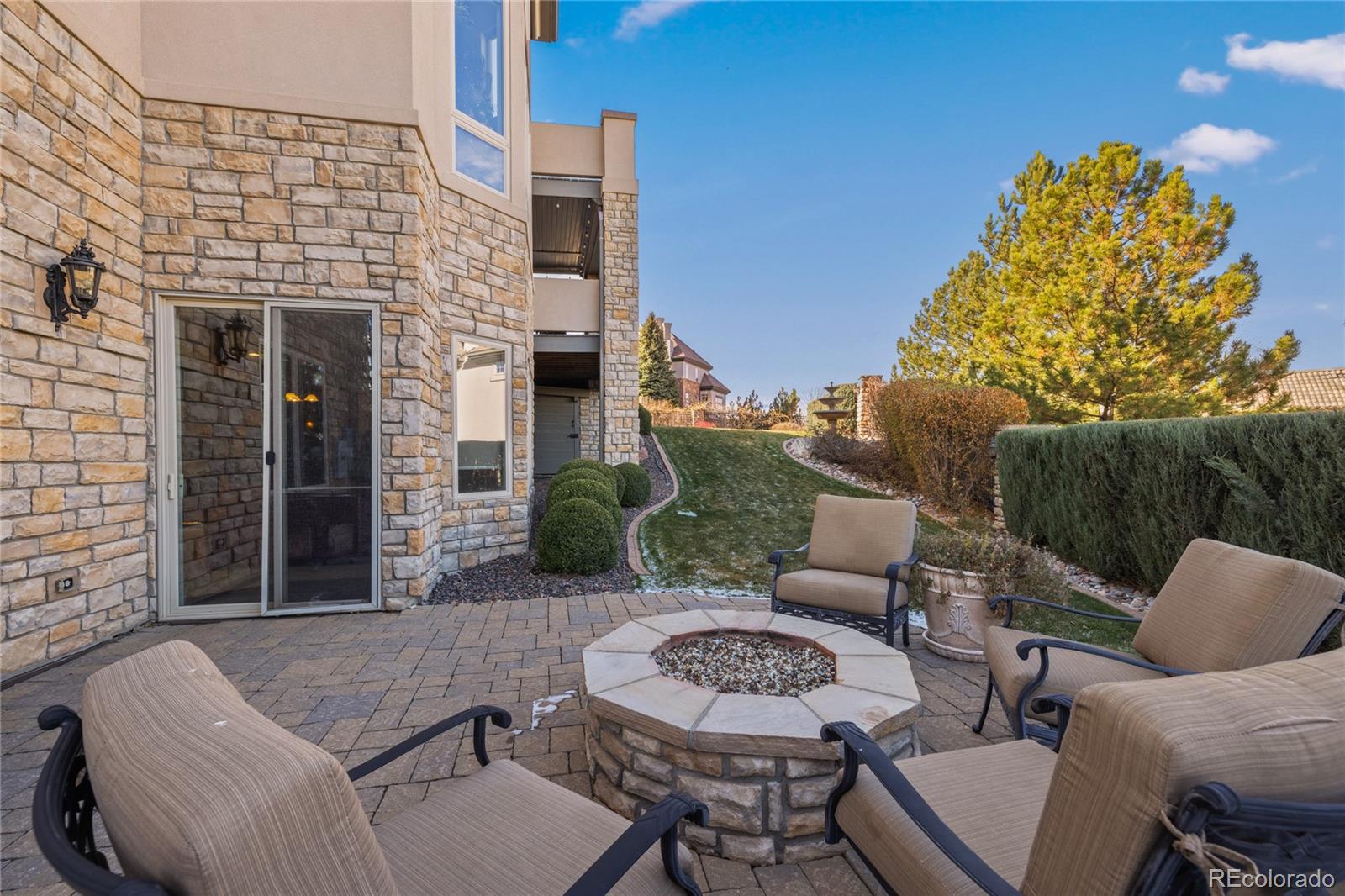 8751 Crooked Stick Place Lone Tree, CO 80124 - Photo 27 of 50 a view of a patio with couches table and chairs and potted plants