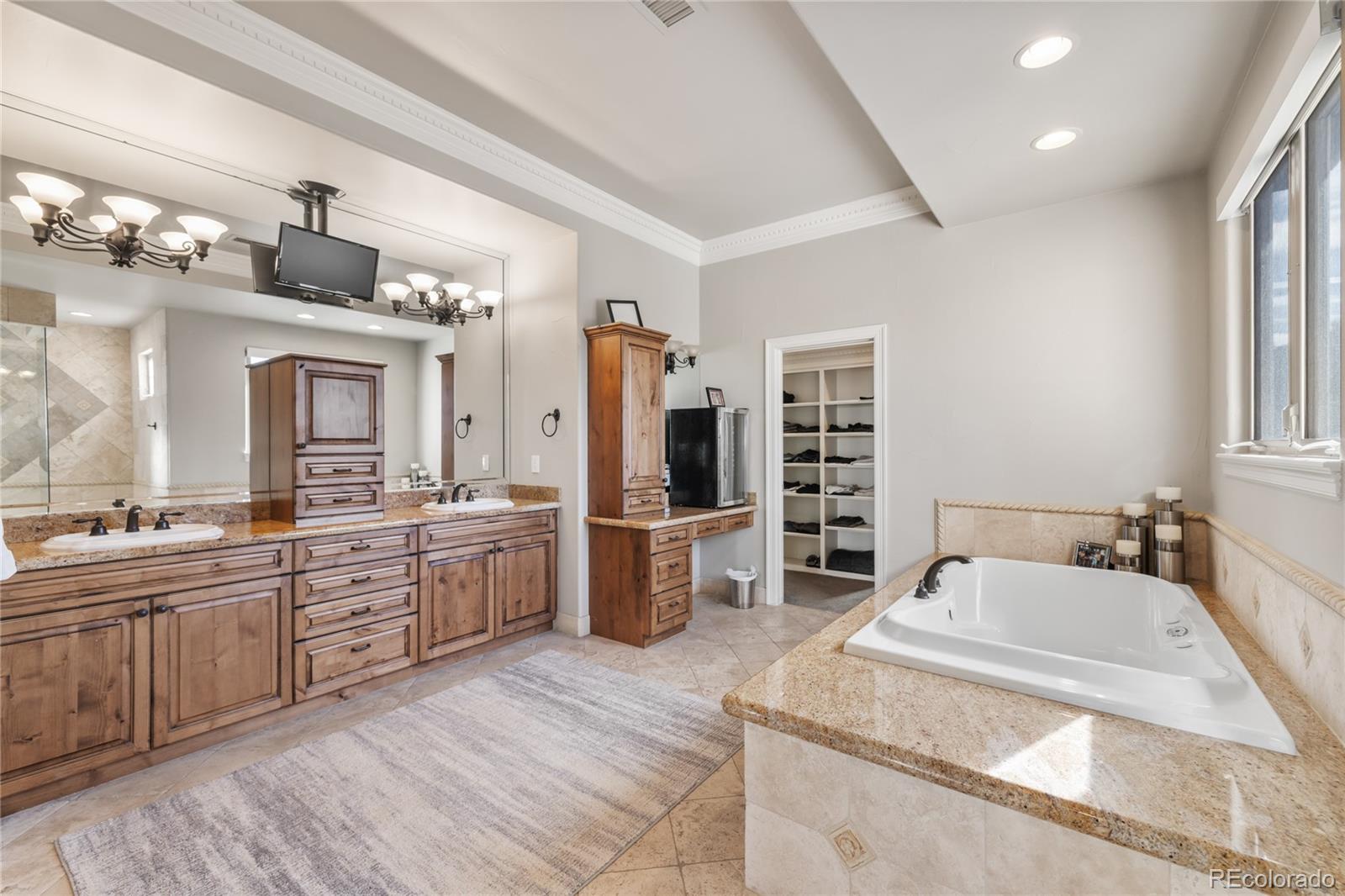 8751 Crooked Stick Place Lone Tree, CO 80124 - Photo 35 of 50 a large kitchen with kitchen island a sink stainless steel appliances and cabinets