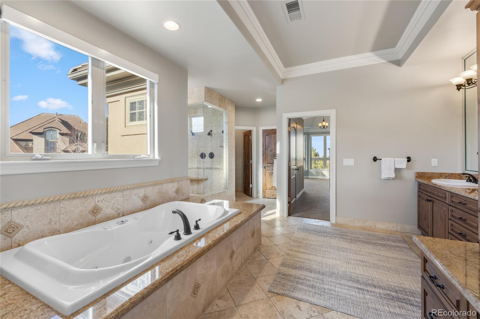 8751 Crooked Stick Place Lone Tree, CO 80124 - Photo 36 of 50 a bathroom with a bathtub and a shower