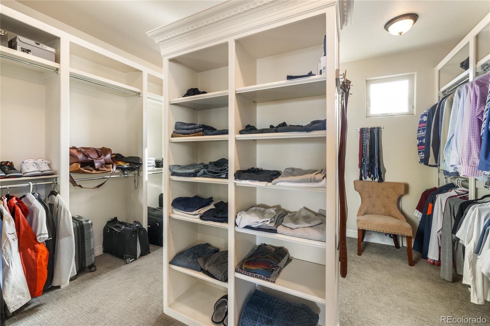 8751 Crooked Stick Place Lone Tree, CO 80124 - Photo 38 of 50 a view of walk in closet with clothes and shoes