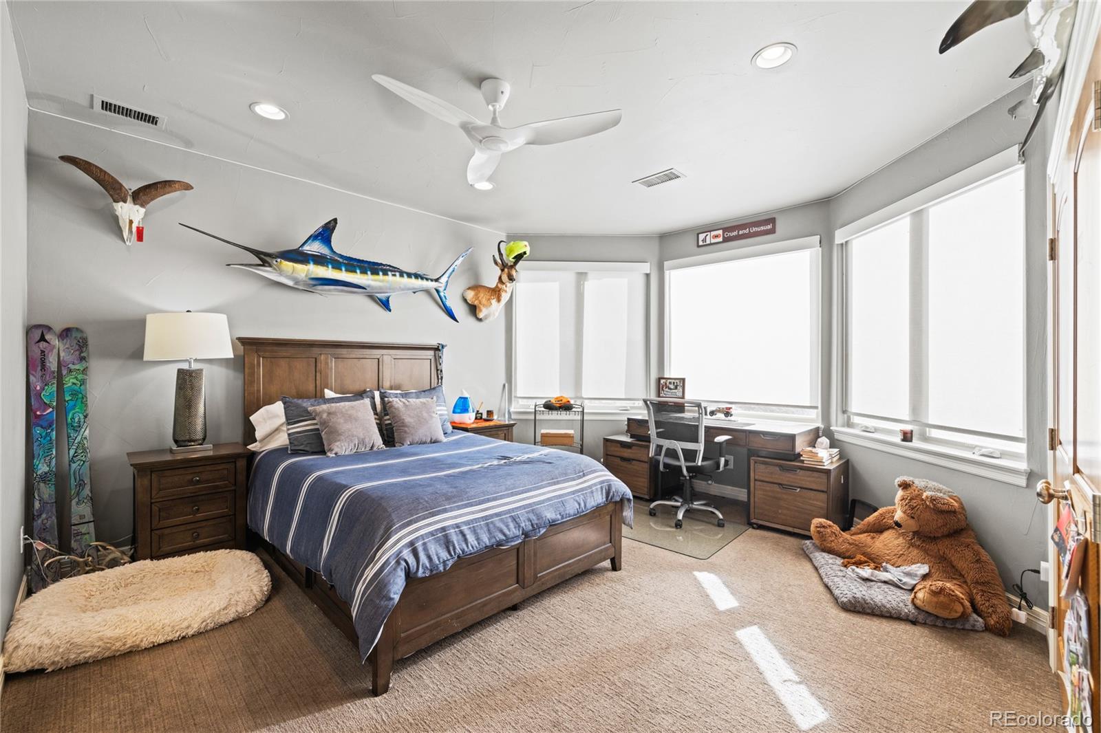 8751 Crooked Stick Place Lone Tree, CO 80124 - Photo 45 of 50 a bedroom with a bed a large window and couch
