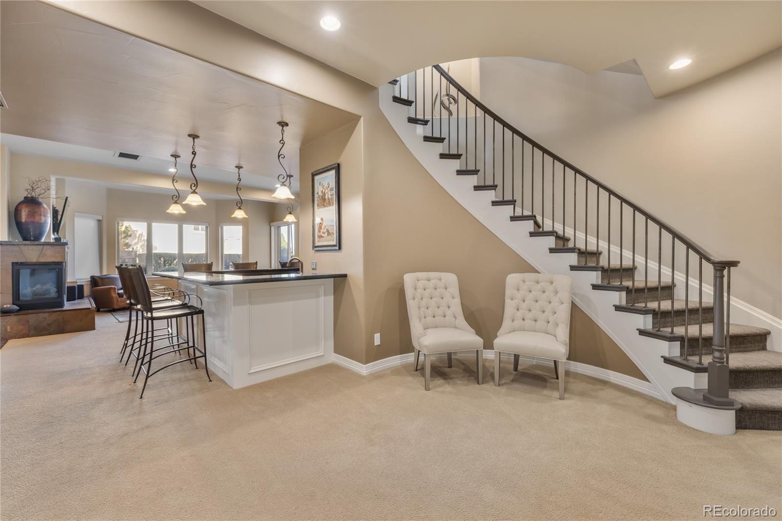 8751 Crooked Stick Place Lone Tree, CO 80124 - Photo 47 of 50 a view of a livingroom with furniture and stairs