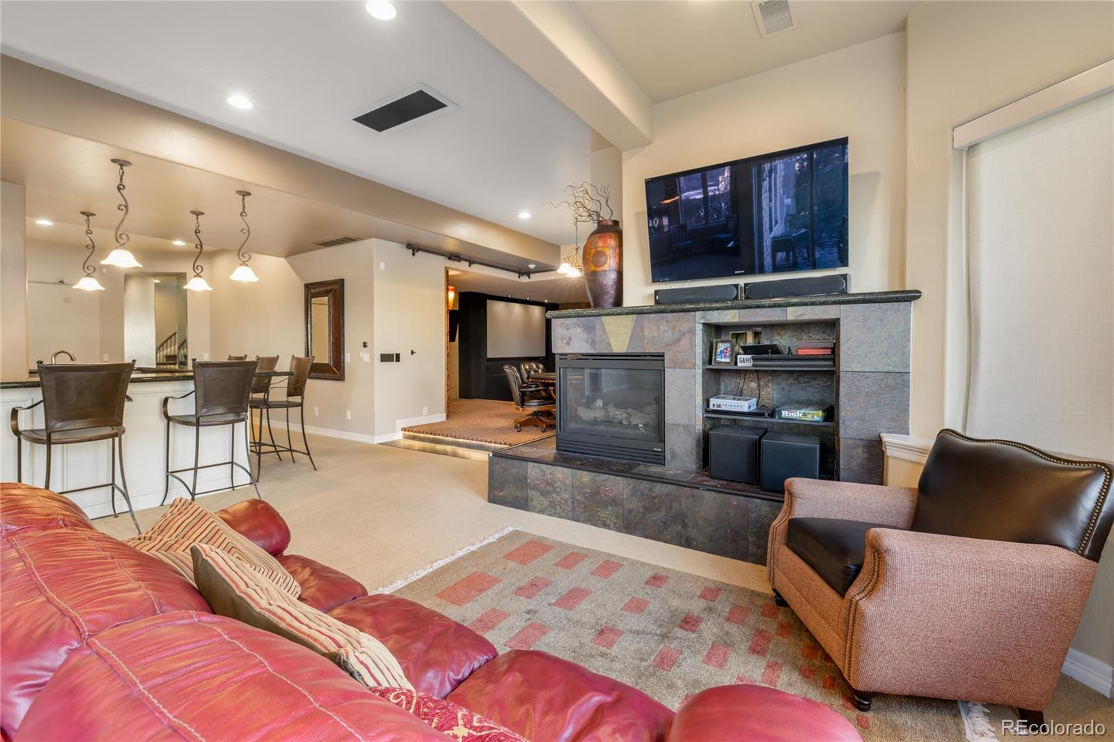8751 Crooked Stick Place Lone Tree, CO 80124 - Photo 50 of 50 a living room with furniture and a flat screen tv