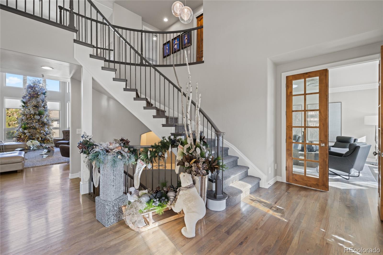 8751 Crooked Stick Place Lone Tree, CO 80124 - Photo 5 of 50 a view of entryway and hall with wooden floor