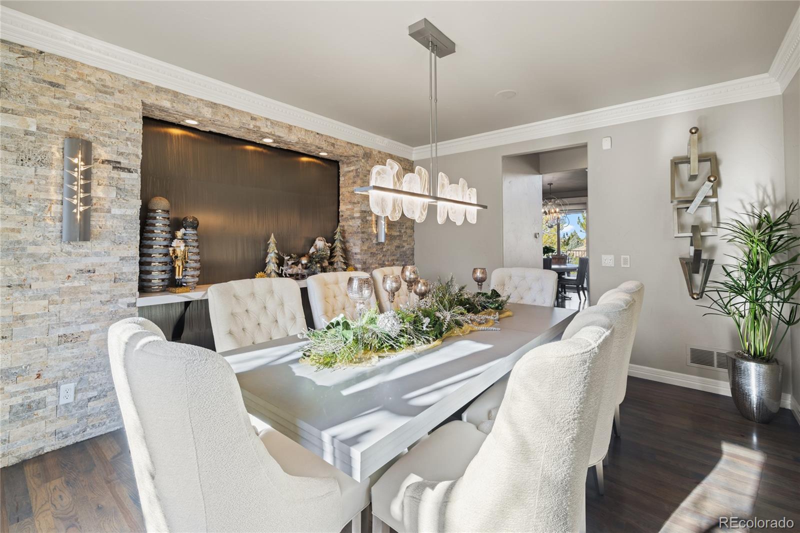 8751 Crooked Stick Place Lone Tree, CO 80124 - Photo 9 of 50 a view of a dining room with furniture window and wooden floor