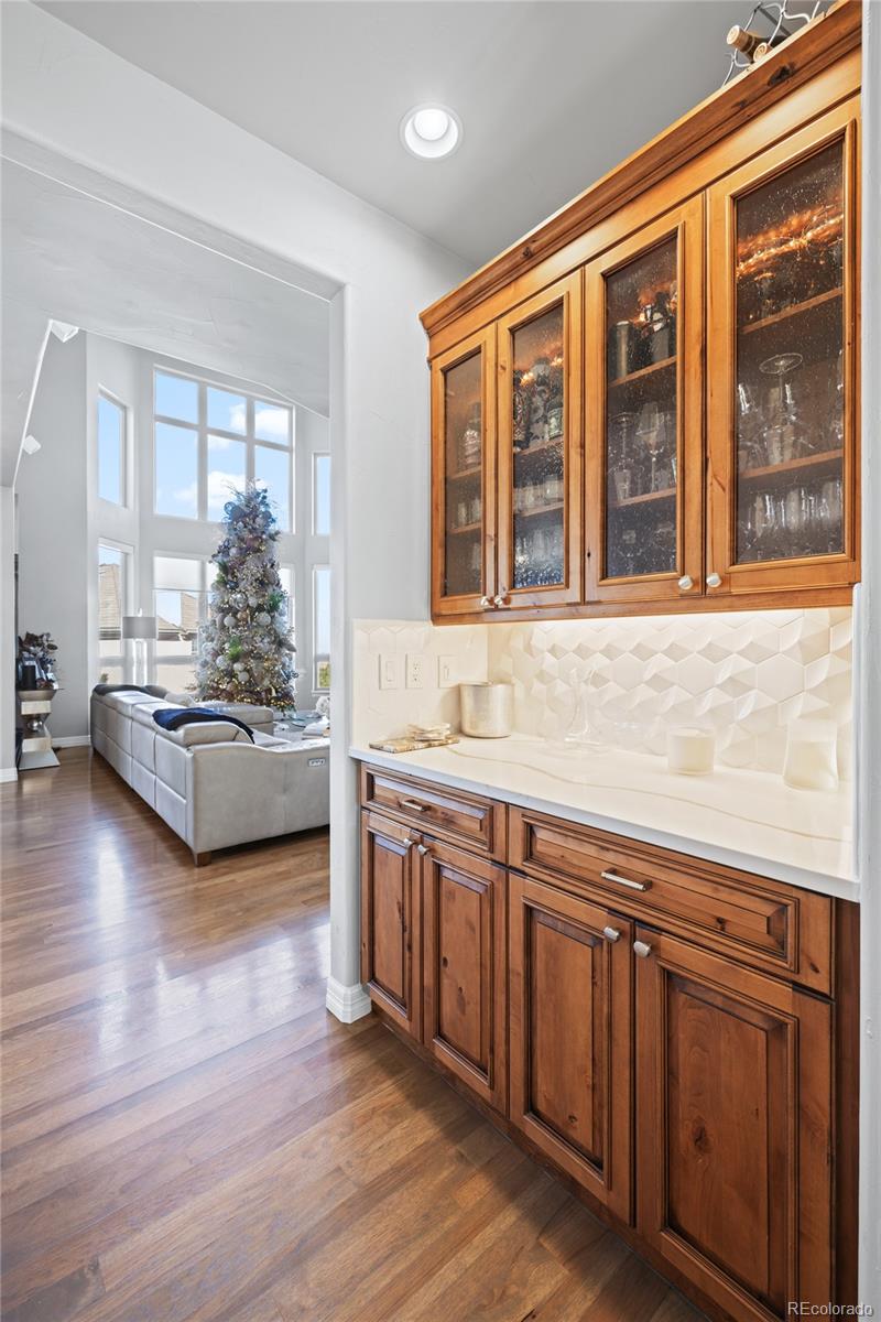 8751 Crooked Stick Place Lone Tree, CO 80124 - Photo 10 of 50 a living room with hard wood floors and a large window