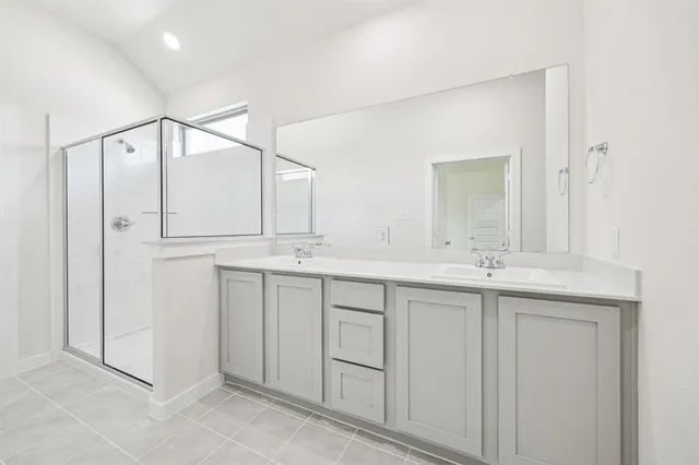 a bathroom with a double vanity sink and mirror