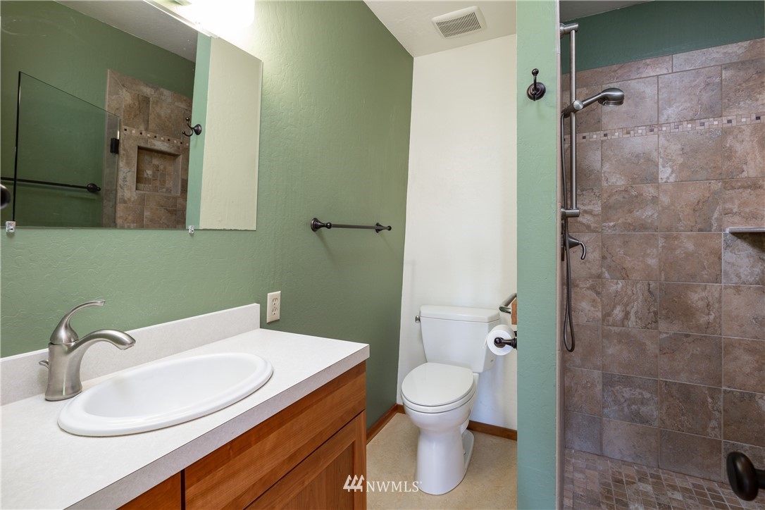 5852 Storr Road Ferndale, WA 98248 - Photo 13 of 25 a bathroom with a sink a toilet and shower