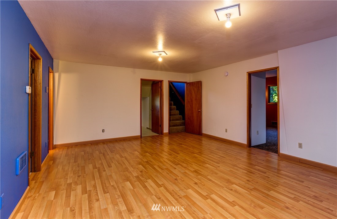 5852 Storr Road Ferndale, WA 98248 - Photo 15 of 25 a view of an empty room with wooden floor and a window