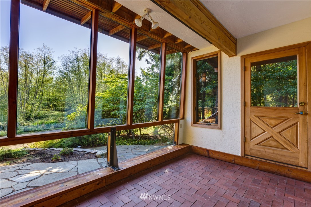 5852 Storr Road Ferndale, WA 98248 - Photo 18 of 25 a view of porch with a bench in front of glass door