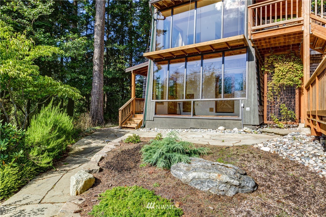 5852 Storr Road Ferndale, WA 98248 - Photo 20 of 25 a backyard of a house with large tree and wooden fence