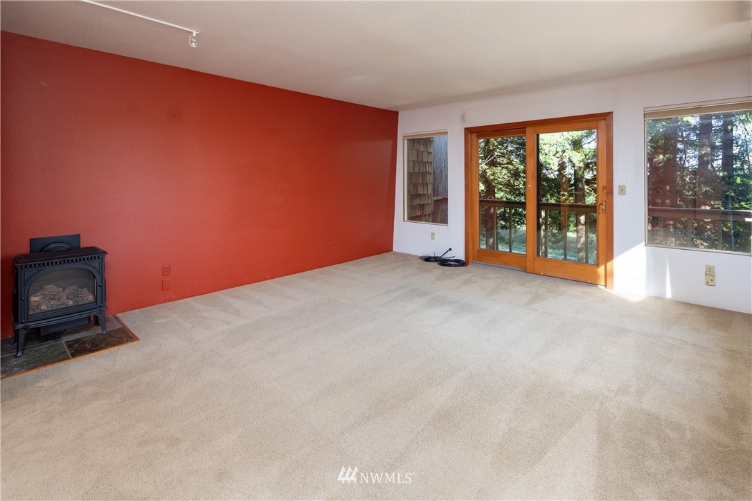 5852 Storr Road Ferndale, WA 98248 - Photo 6 of 25 a view of an empty room with a fireplace and a window