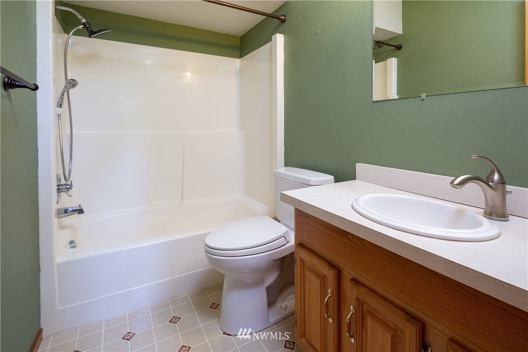 5852 Storr Road Ferndale, WA 98248 - Photo 10 of 25 a bathroom with a sink toilet and shower