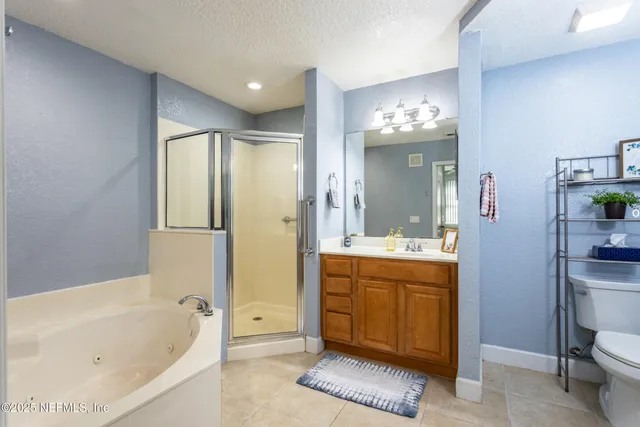 a bathroom with a bathtub shower and sink