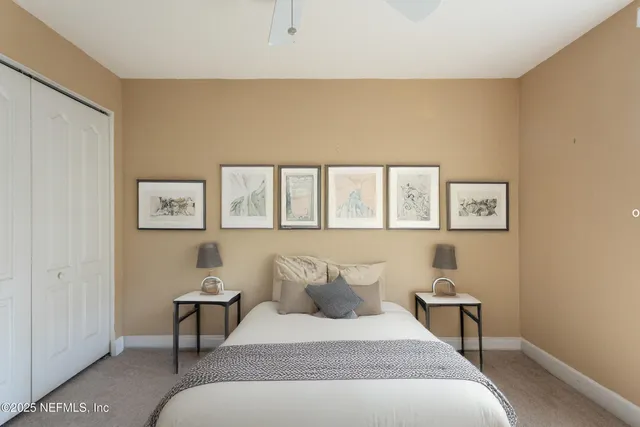 a bedroom with a large bed and a lamp