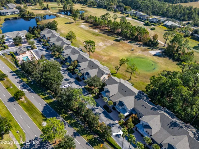 an aerial view of residential houses with outdoor space