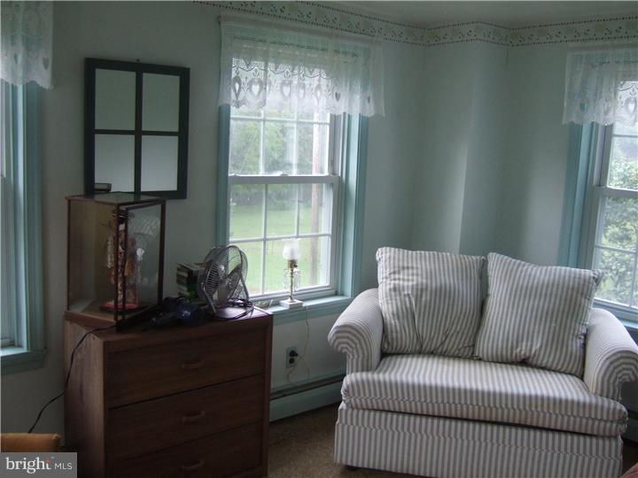 4052 Lehnenberg Road Riegelsville, PA 18077 - Photo 14 of 19 a living room with furniture a window and a flat screen tv