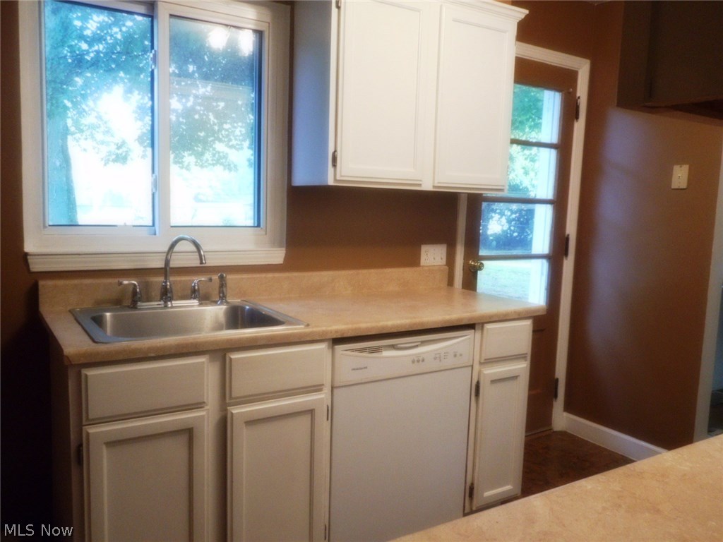 908 Jacoby Road Akron, OH 44321 - Photo 8 of 24 The kitchen has neutral counter tops and a door which leads to the patio and fenced backyard.