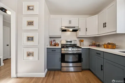 a kitchen with a refrigerator and a stove