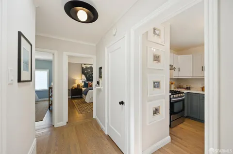 a bedroom with a bed and dresser with mirror