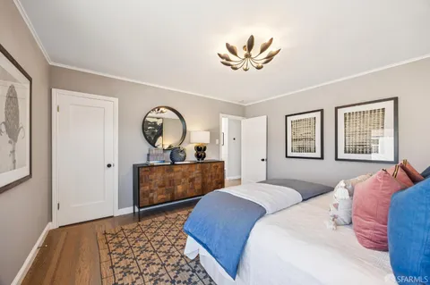 a bedroom with two beds and a window